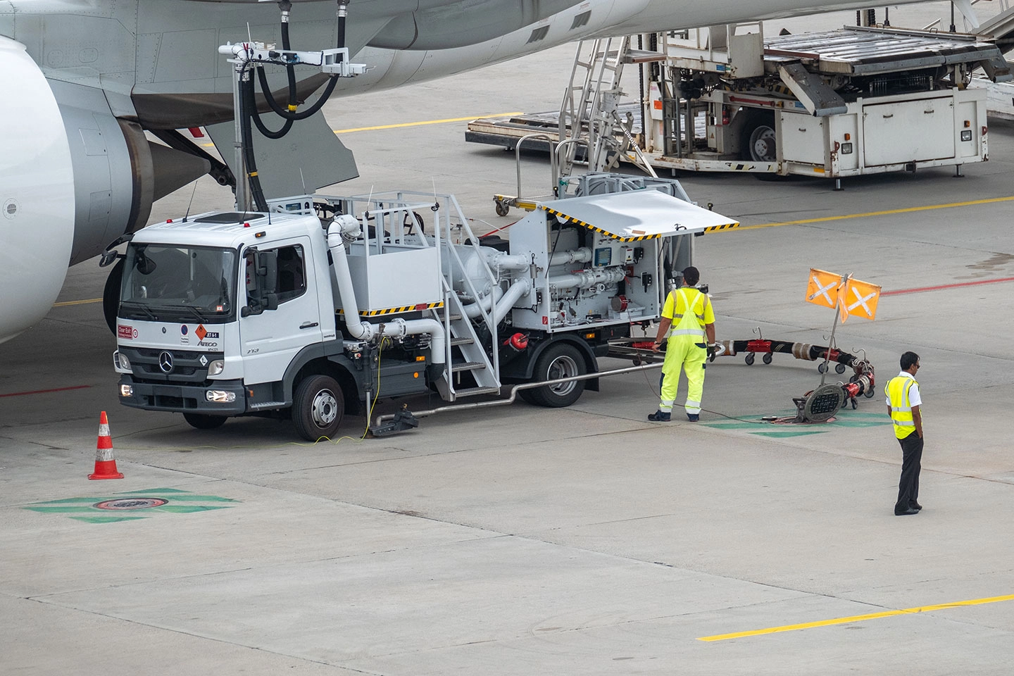 airport employees refueling an aircraft airport employees refueling an aircraft
