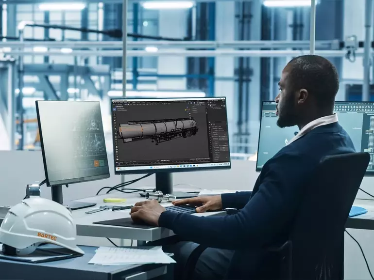 Man sitting at a desk behind a computer Man sitting at a desk behind a computer