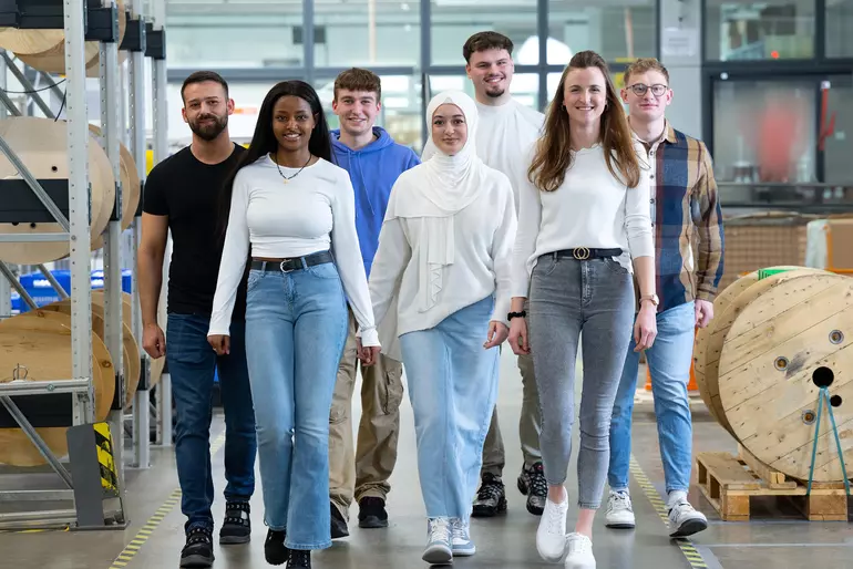 Interns walking through BARTEC production site