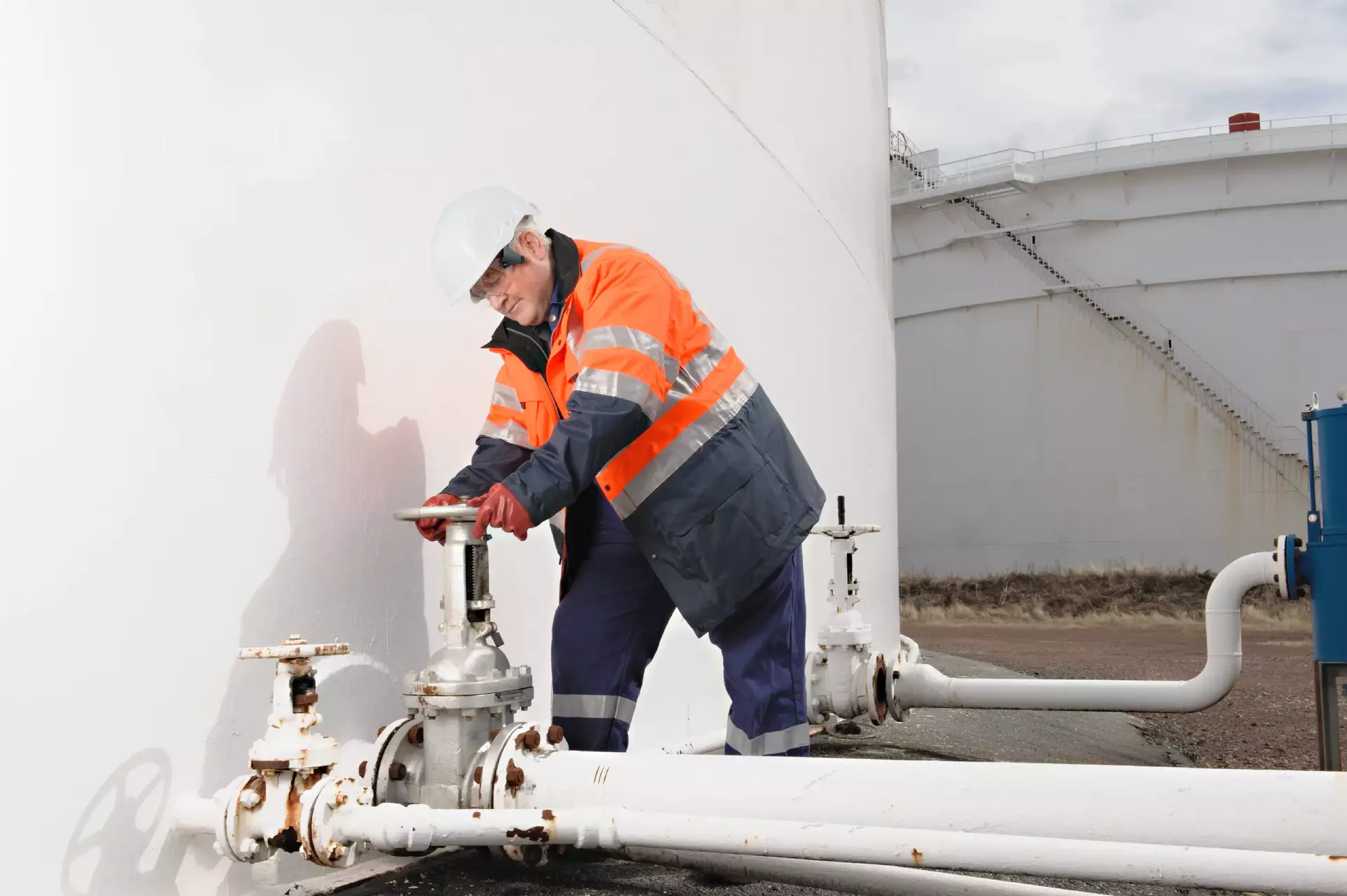 Caucasian technician checking fuel storage tank