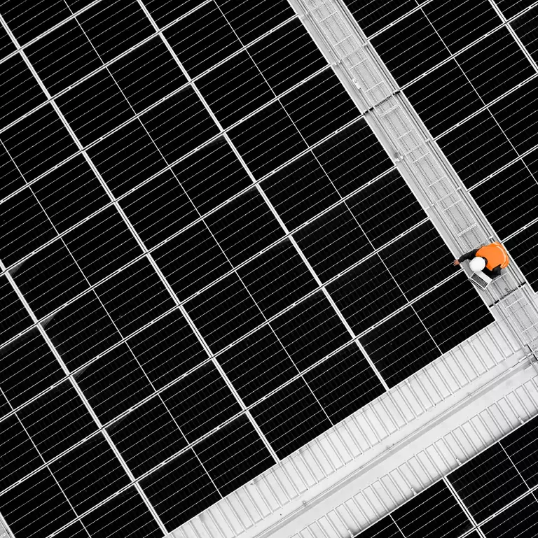 High angle view of engineer holding digital tablet to analysis data of photovoltaic panel system during installation on roof