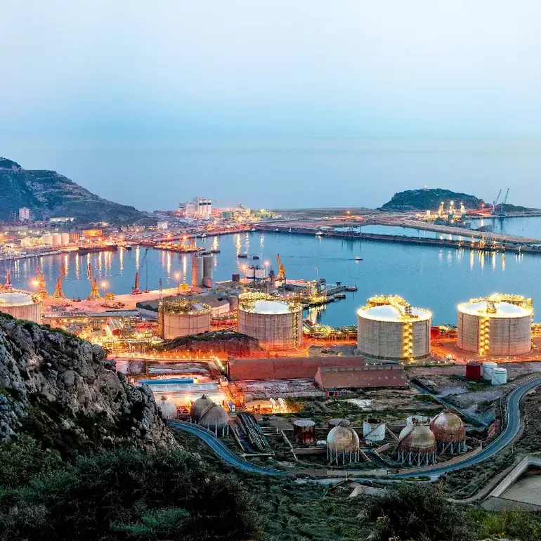 Petrochemical plant and oil refinery industry by the sea at sunset Petrochemical plant and oil refinery industry by the sea at sunset